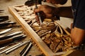 Skilled craftsman doing wood carving using traditional method